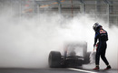 Sebastian Vettel abandons his smouldering Red Bull