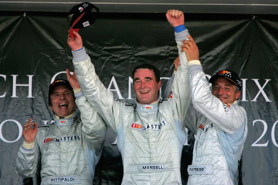 Nigel Mansell celebrates winning the Grand Prix Masters in Kyalami with Emerson Fittipaldi and Ricardo Patrese