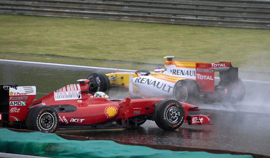 Giancarlo Fisichella spins his Ferrari in front of Romain Grosjean during qualifying for the Brazilian Grand Prix