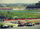 Cars file through the Senna Esses