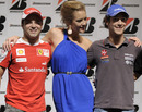Brazilian drivers Felipe Massa and Bruno Senna pose for a photo with model Gianne Albertoni