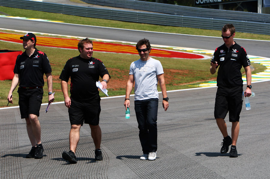 Timo Glock and his Virgin Racing engineers walks the track