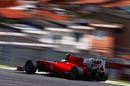 Fernando Alonso speeds past the favelas
