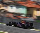 Sebastian Vettel speeds past the favelas on the way to setting the quickest time of the day