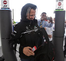 Michael Schumacher arrives in the paddock wearing his rain coat