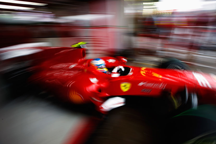 Fernando Alonso leaves the garage on full wet tyres