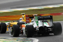 Adrian Sutil tries to find a way past Vitaly Petrov