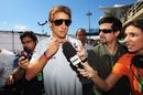 Jenson Button talks to the media after escaping from an attempted armed robbery