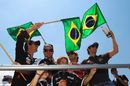 The Brazilian drivers wave to their home fans during the drivers' parade