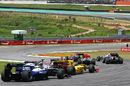 Cars sweep round at the start of the Brazilian Grand Prix