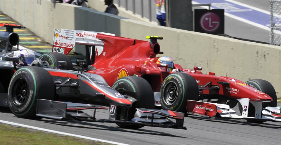 Fernando Alonso laps Christian Klien