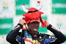 Mark Webber tries on a Red Bull hat