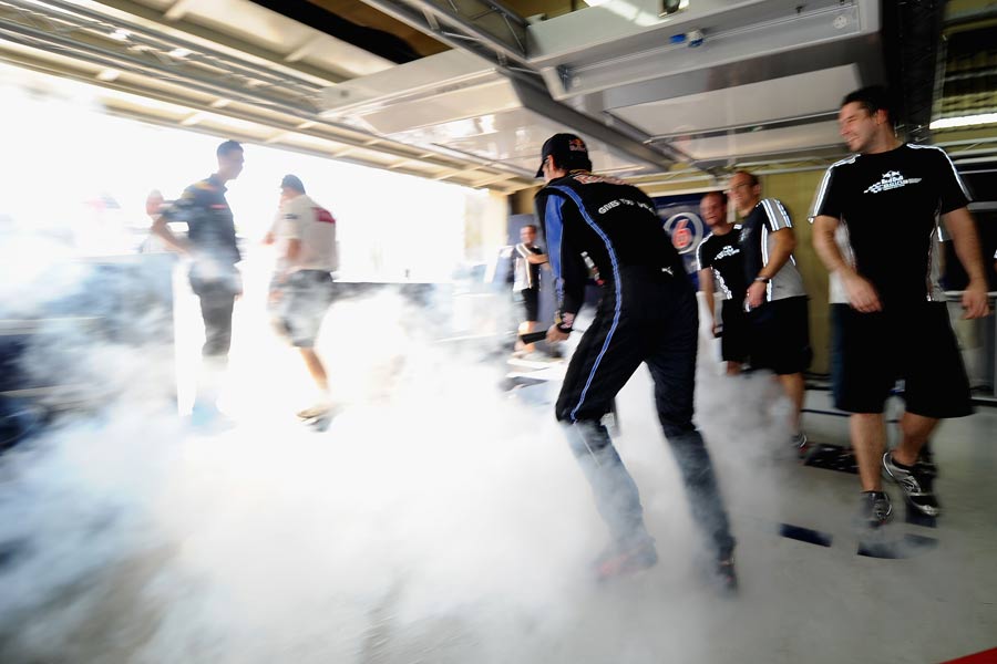 Mark Webber sprays a fire extinguisher in the garage