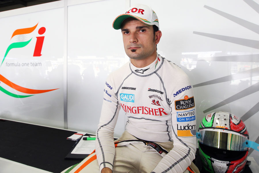 Tonio Liuzzi relaxes at the back of the Force India garage