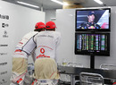 Jenson Button and Lewis Hamilton watch the press conference