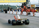 Emerson Fittipaldi wins in front of his McLaren pit crew