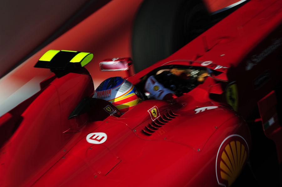 Fernando Alonso corners hard in his Ferrari