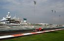 Fernando Alonso speeds past the marina
