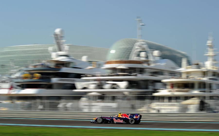 Mark Webber drives past the marina