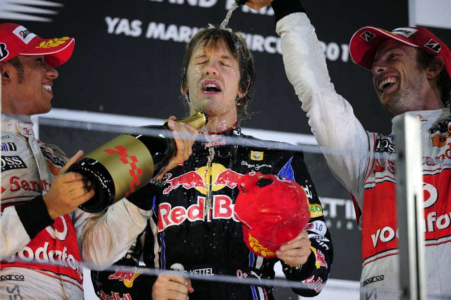 Lewis Hamilton and Jenson Button congratulate Sebastian Vettel on the podium
