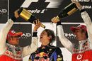 Lewis Hamilton and Jenson Button douse Sebastian Vettel with champagne