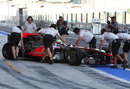 Oliver Turvey is wheeled back into the McLaren garage