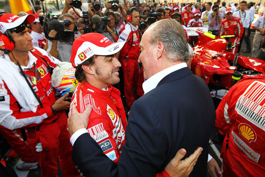 King Carlos of Spain greets Fernando Alonso on the grid