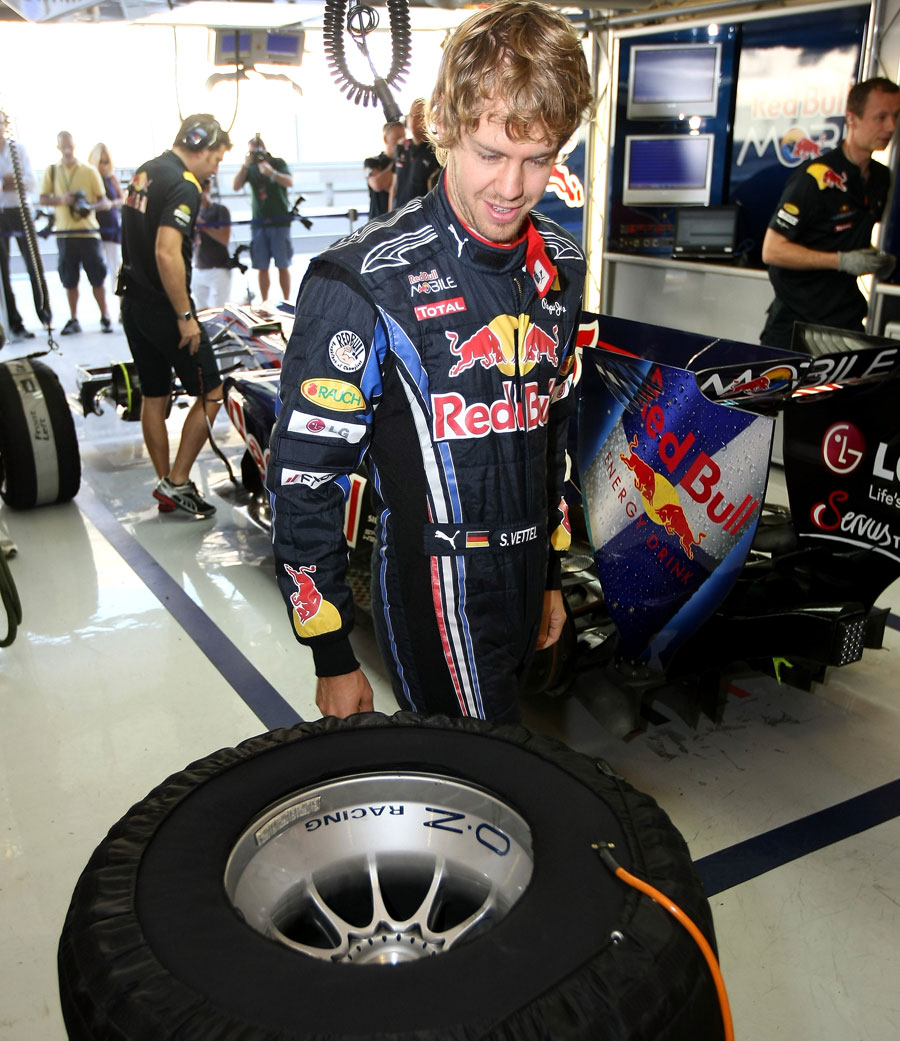 Sebastian Vettel keeps an eye on his pre-heated tyres