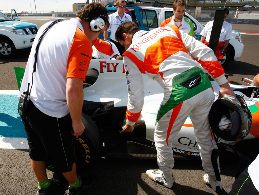 Adrian Sutil points out a problem after his car stopped on track