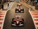 Felipe Massa and Fernando Alonso head out the pits