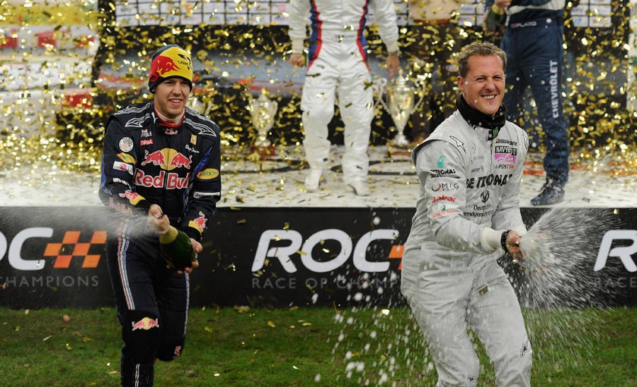 Sebastian Vettel and Michael Schumacher celebrate winning the Nations Cup