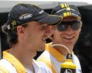 Robert Kubica and Vitaly Petrov arrive prior to the start of the Malaysian Grand Prix