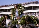 Jackie Stewart celebrates victory on the podium with Tyrrell team-mate Francois Cevert and Emerson Fittipaldi
