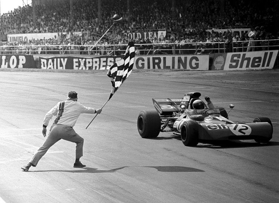 Jackie Stewart punches the air in delight after taking his second and last British GP victory