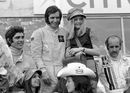 Emerson Fittipaldi celebrates on the podium with Francois Cevert and Denny Hulme