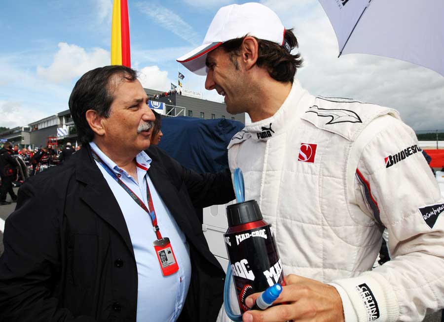 HRT owner Jose Ramon Carabante talks to Pedro de la Rosa on the grid
