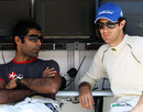 Karun Chandhok and Bruno Senna relax on the pit wall