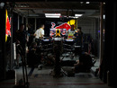 Red Bull mechanics work on Mark Webber's car late into the night