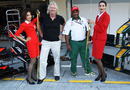 Sir Richard Branson and Tony Fernandes are measured for stewardess outfits in the pit lane