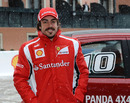 Fernando Alonso poses for a photo in the snow
