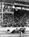 AJ Foyt raises his hand in victory as he crosses the finish line