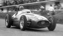 Juan Manuel Fangio at speed down the hill past the pits