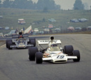 Peter Revson on trackk in the McLaren ahead of Emerson Fittipaldi