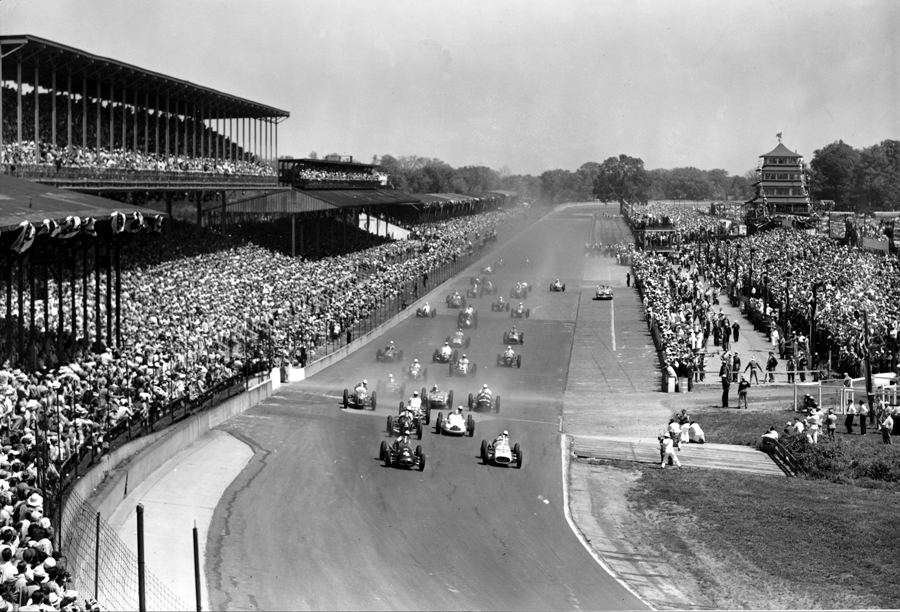 Thirty-three competitors in the Indianapolis 500-mile race approach the first curve
