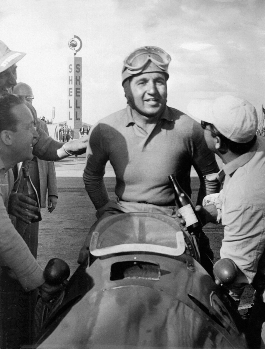 Alberto Ascari climbs from his Ferrari after wining the German Grand Prix and securing his first world title