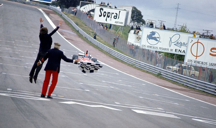Luca di Montezemolo jumps for joy as Niki Lauda crosses the line for victory