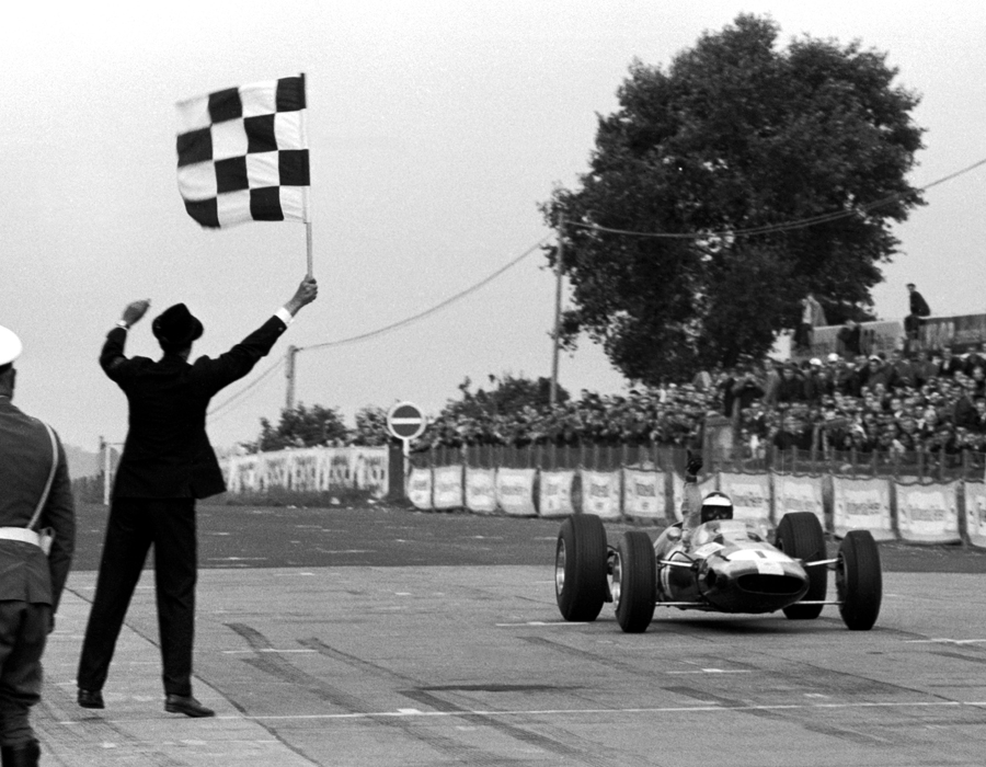 Jim Clark crosses the line to win the German Grand Prix and secure his second world title