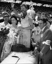 Pat Flaherty waves from the winner's circle at Indianapolis with his wife