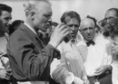 Mike Hawthorn toasts team-mate and race winner Peter Collins
