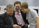 Mario Andretti shows off his phone to Christian Horner and Sebastian Vettel